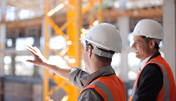 stock photo - two men in hard hats at construction site