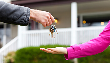 Stock photo - man passing keys to woman.