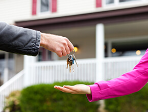 Stock photo - man passing keys to woman.