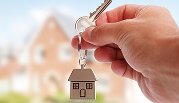 Stock photo - hand holding a key on a house keyring.