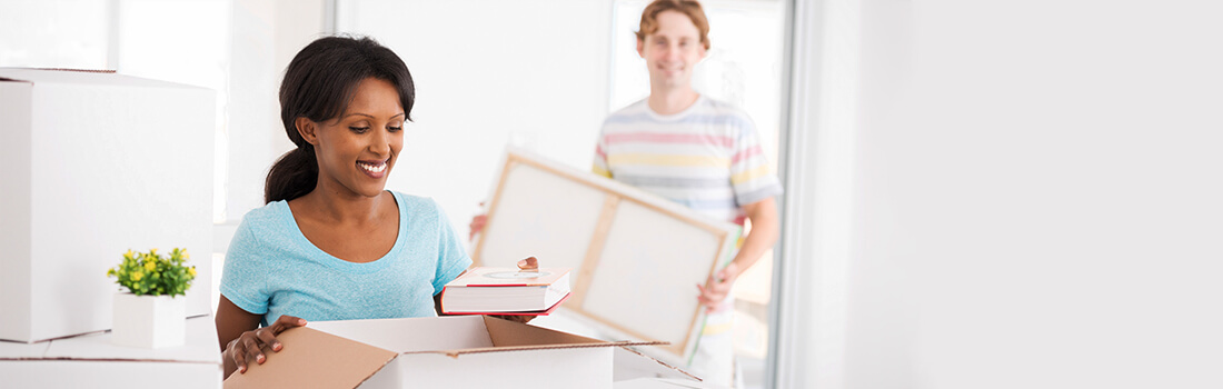 Stock Photo - woman and man unpacking boxes.