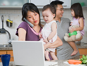 Stock photo - man, woman and two kids in the kitchen.