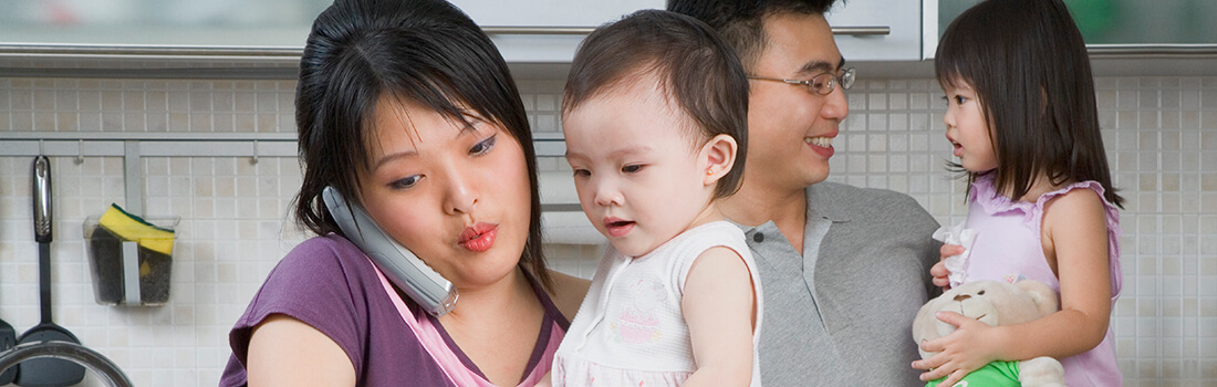 Stock photo - man, woman and two kids in the kitchen.