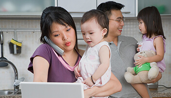 Stock photo - man, woman and two kids in the kitchen.