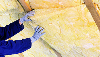 Stock photo - insulation being placed in ceiling.