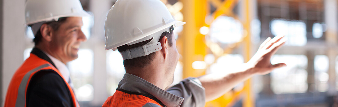 stock photo - two men in hard hats at construction site