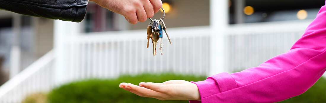 Stock photo - passing keys from one person to another.