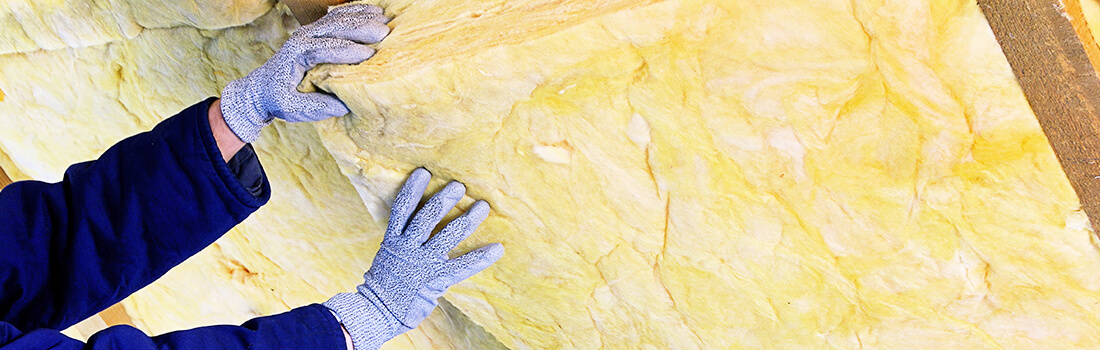 Stock photo - insulation being placed in ceiling.