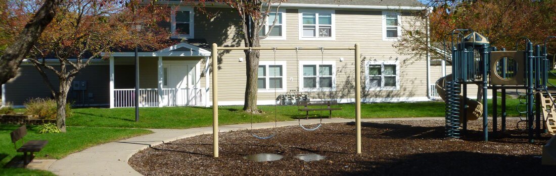 Exterior photo of the tot lot playground McKay Manor, a public housing townhome development in Apple Valley.